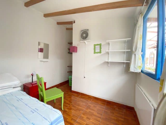 Furnished student room with desk, shelves and natural light at Casa Yllika Lima Peru
