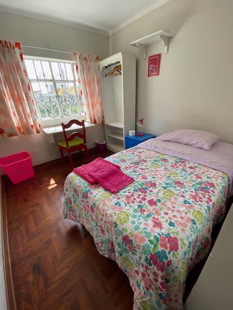 Furnished student room with bed, desk and wardrobe at Casa Yllika student housing Lima Peru