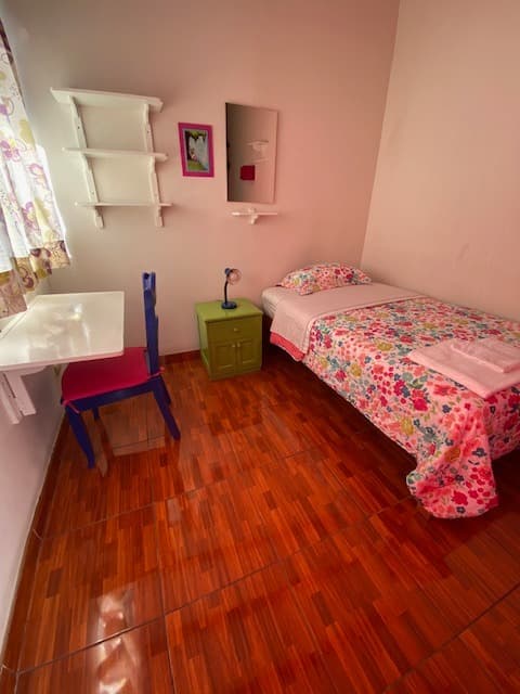 Single room with desk, mirror, safety box and complete bed linen at Casa Yllika student accommodation Lima Peru