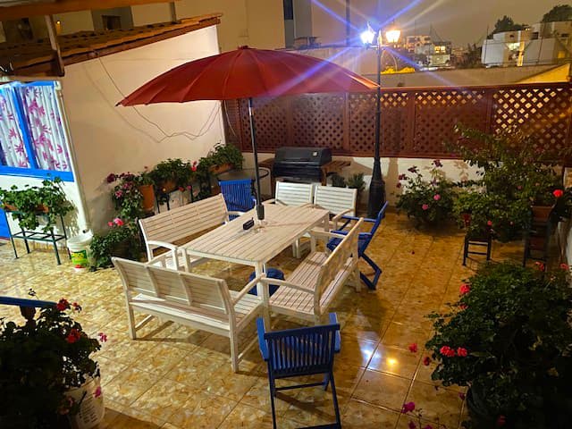 Rooftop terrace at night with garden and seating area at Casa Yllika student housing Jesus Maria Lima Peru